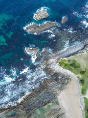 Drone downwards view of rocks at beach,