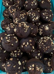 These are small, round chocolate muffins with a rich dark brown color