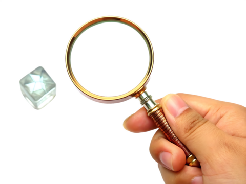 Hand holding magnifying glass examining ice cube isolated on a transparent background - Powered by Adobe