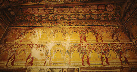 Intricate Buddhist Wall Paintings in Ancient Temple Setting