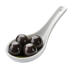 Black pearl tapioca balls in white ceramic spoon close up transparent background