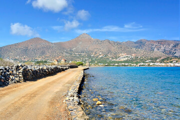 Dirt road of the sea coast of the island Crete, Elounda town, Greece	