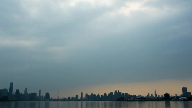Cloudy skyline over a city on the water during a calm afternoon