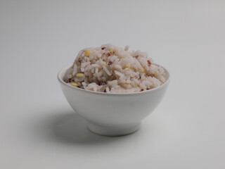 Rice cooked with grain mix in white bowl, isolated