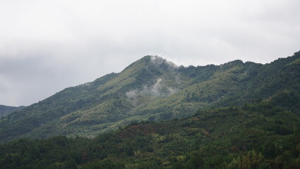 The beautiful mountains view with the covered fog on them