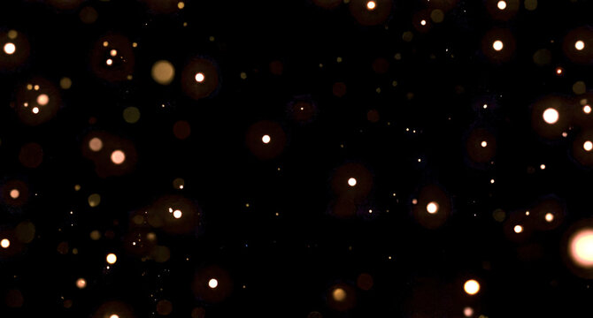 Glowing orange bokeh lights on dark background