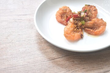 deep fried salty river shrimp with chop garlic and chili pepper arranging on plate 