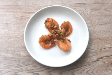 deep fried salty river shrimp with chop garlic and chili pepper arranging on plate 