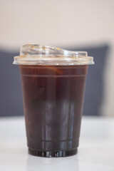 Ice Americano or iced black coffee on the table at a coffee shop.