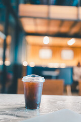Ice Americano on table at cafe, a cold refreshing