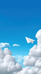 Fototapeta premium Paper airplane soars through fluffy clouds against bright blue sky, evoking sense of freedom and adventure