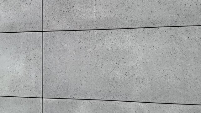 se-up view of facade tiles crafted from architectural concrete, highlighting their smooth surface, modern texture, and geometric arrangement.