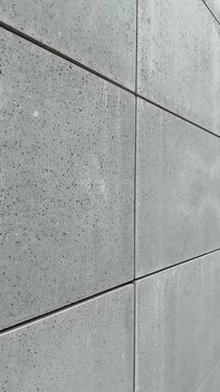 se-up view of facade tiles crafted from architectural concrete, highlighting their smooth surface, modern texture, and geometric arrangement.