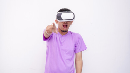 Young Asian man playing with a VR glasses isolate on white background, wearing purple lilac t-shirt