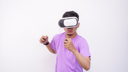 Young Asian man playing with a VR glasses isolate on white background, wearing purple lilac t-shirt