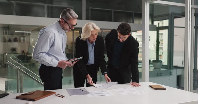 Business people, meeting and documents with planning at office, admin or risk management agency. Woman, men and team with talk, feedback or review policy for financial compliance at insurance company