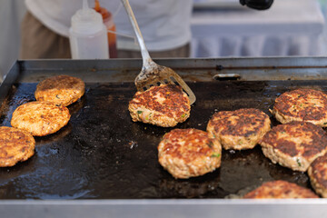 Sizzling hamburger patties on the iron plate
