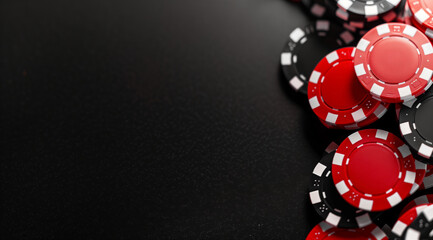 Stack of Red and Black Poker Chips on Casino Table with Dark Background