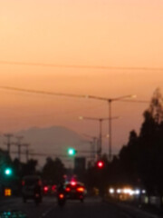 Fototapeta premium Blurry picture of traffic at sunset
