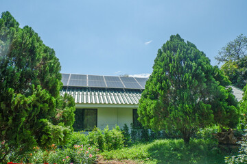 Solar panel on a roof reflecting the sun and blue sky,photovoltaic panels on the roof,Roof Of solar...