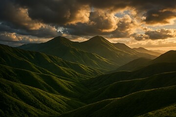 Dramatic mountain range bathed in golden sunset light under a stormy sky