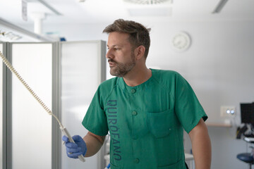 Surgeon using medical equipment in operating room