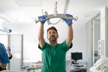 Nurse installing patient lift in hospital room