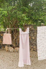 Different clothes drying on laundry line against garden background,clothes hanging laundry on...
