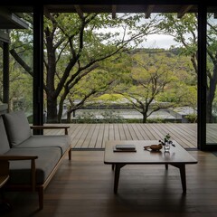 Obraz premium Japanese-style home interior with panoramic window, terrace overlooking trees, minimalist sofa and coffee table, natural light, calm and serene atmosphere