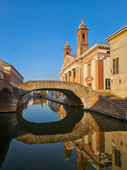 San Pietro Church and Brick Arch Bridge in Comacchio, Italy with Reflection in Canal