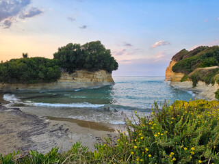 Beach at Canal d'Amour cove near Corfu, Greece, featuring turquoise water, rocky cliffs, and lush...