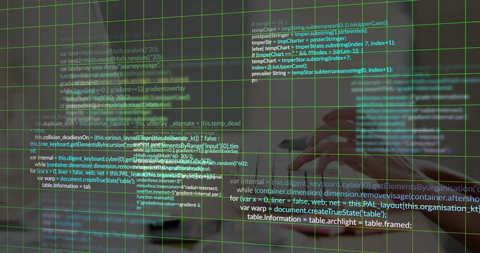 Displaying green code overlay, silver laptop computer resting on wooden desk, with hovering hand