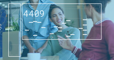 Collaborating group, including woman in sweater around table in office with laptop digital overlay