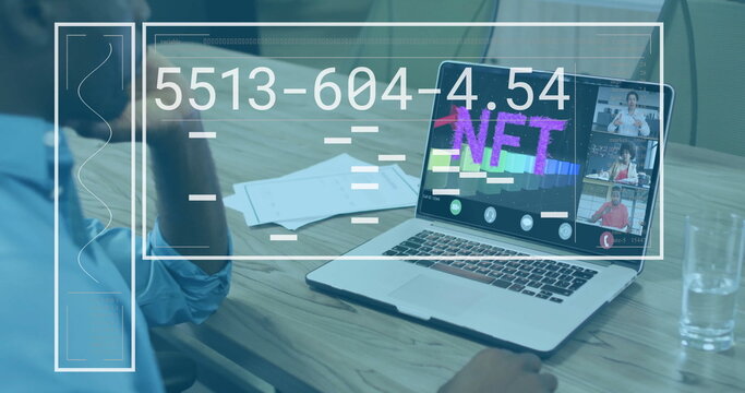 Adult male studying NFT graphic on laptop at conference table, with documents and UI overlays - Powered by Adobe