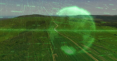 Displaying neon-green scanning sphere over farmland with grid lines, data and winding dirt road
