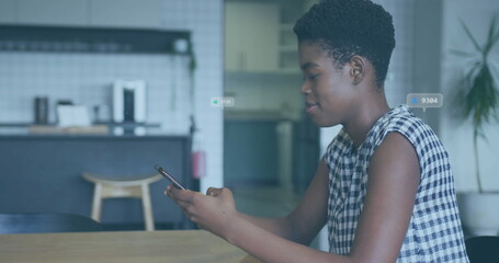 Scrolling woman in checkered top tapping smartphone at kitchen table, copy space