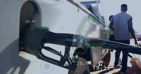 Inserting green fuel nozzle into truck fill port at gas station, with digital readouts, copy space