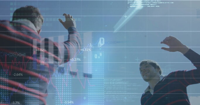 Cheering, two colleagues in striped polos raising arms on roof, with digital data overlays