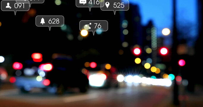 Displaying digital notification icons overlaying night city street, with blurred cars, bokeh lights