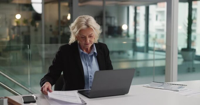 Business, woman and reading document in office for audit, finance report and company budget. Mature person, laptop and paperwork with financial comparison, funding information and investment proposal