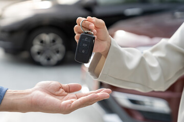 lease, rental car, sell, buy. Dealership manager send car keys to the new owner.  Sales, loan...