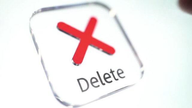 Finger taps delete button on modern interface for data removal or file management action