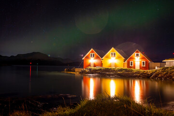 norwegian houses at nicht with northern lights