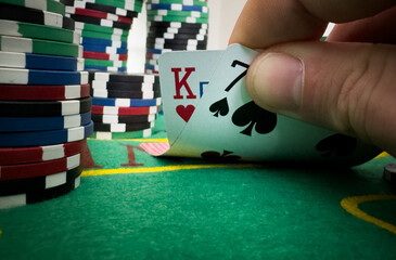 professional poker game. Green poker table with two games. poker player folds by throwing cards on...