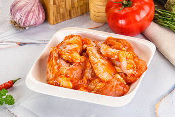 Raw marinated uncooked chicken wings