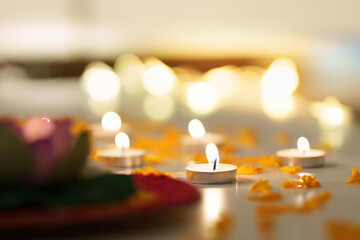 Diwali candles glowing amidst flower petals