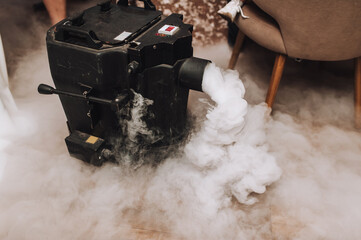 Photograph of a generator, a machine that produces heavy smoke inside a restaurant.