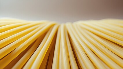 Close-up of uncooked spaghetti pasta, with curved and parallel strands.