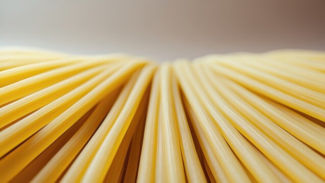 Close-up of uncooked spaghetti pasta, with curved and parallel strands.