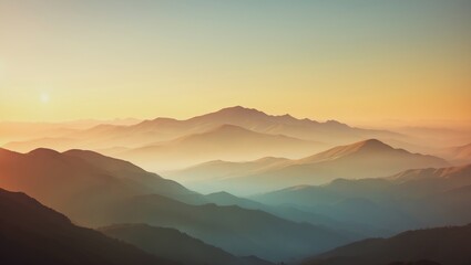 Fototapeta premium Sunset over mountain peaks with layered ridges and soft colors in the sky.